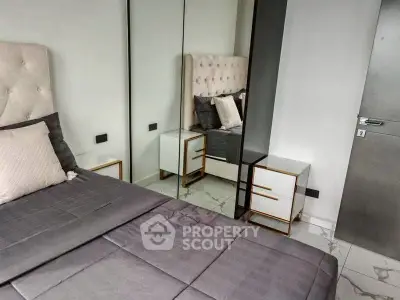 Modern bedroom with mirrored wardrobe and stylish decor