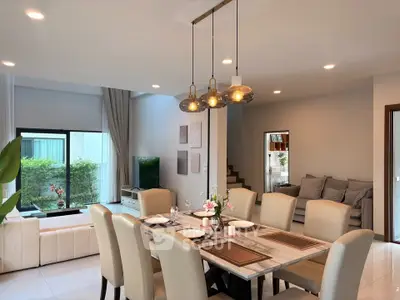 Spacious modern living and dining area with elegant decor and ample natural light.