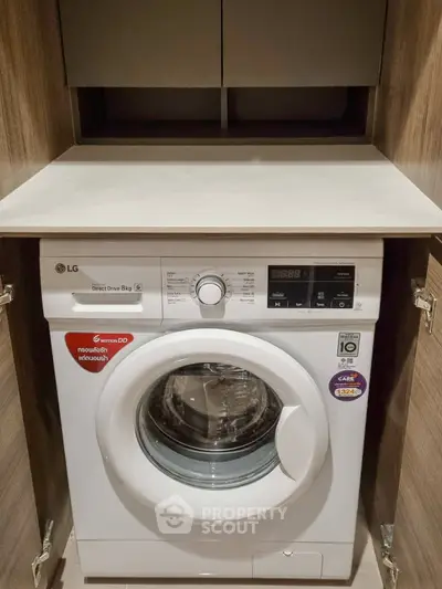 Modern washing machine in sleek wooden cabinet, perfect for efficient laundry space in contemporary homes.