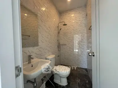 Modern bathroom with sleek white tiles and contemporary fixtures