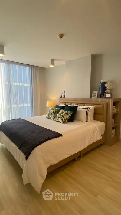 Modern bedroom with stylish decor and natural light