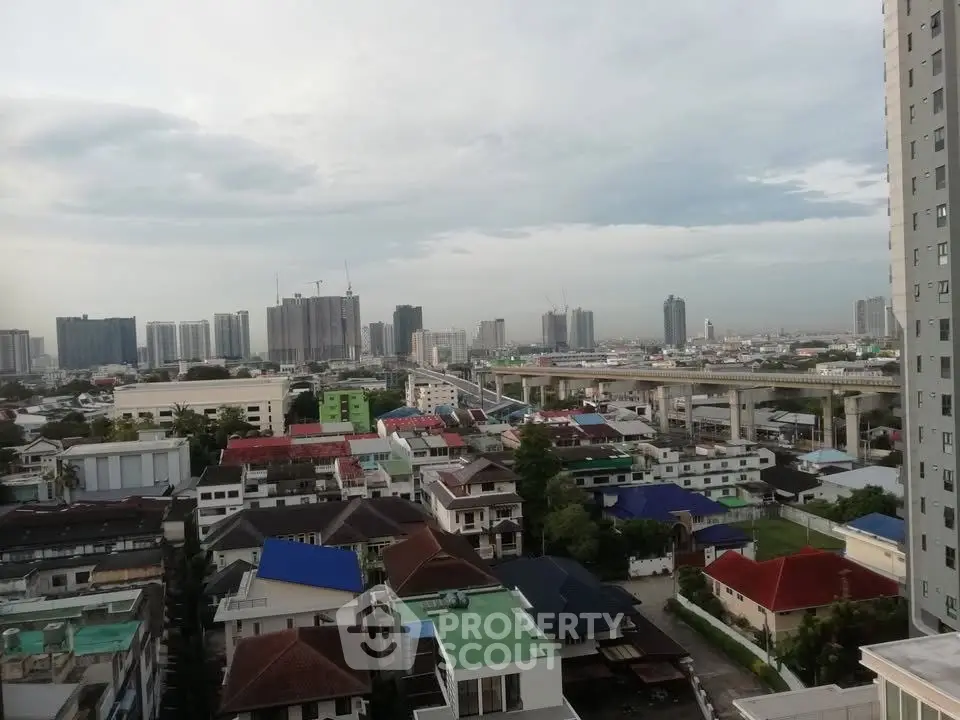 Stunning cityscape view from high-rise building showcasing urban skyline and residential area.
