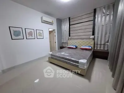 Modern bedroom with stylish decor and air conditioning unit