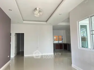 Spacious modern living area with open layout and ceiling fan