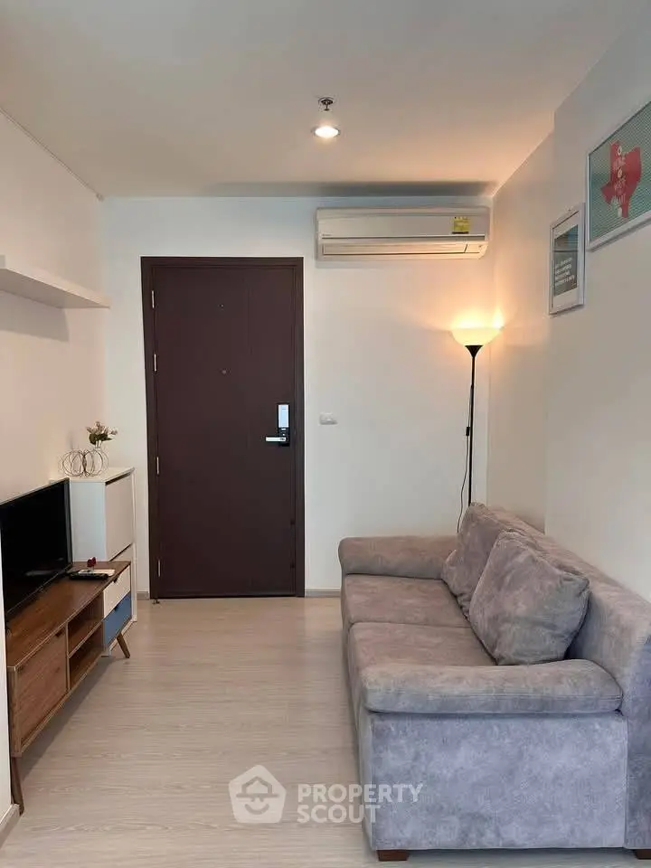 Cozy living room with modern sofa and wall-mounted air conditioner