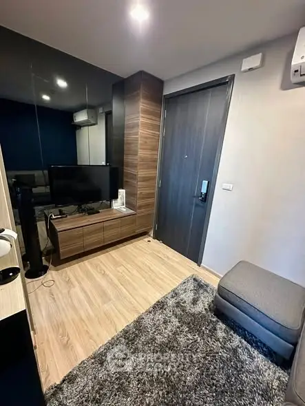 Modern living room with sleek wooden flooring and stylish furniture