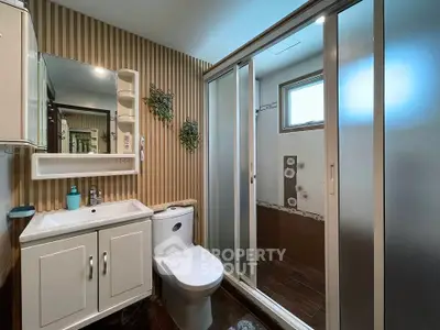 Modern bathroom with sliding glass shower doors and stylish decor