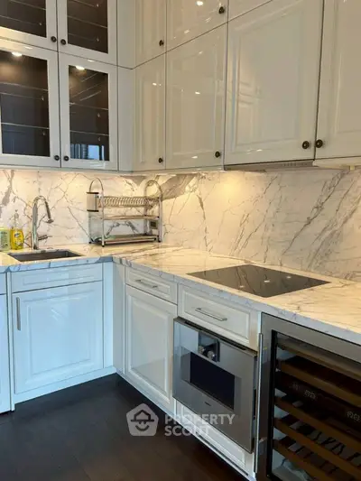 Luxurious modern kitchen with marble countertops and sleek cabinetry.