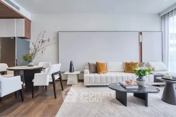 Modern living room with stylish furniture and open layout, featuring a cozy seating area and elegant dining space.
