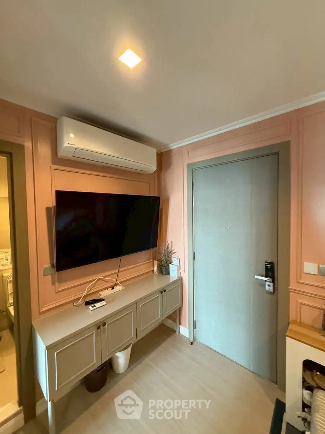 Modern living room with wall-mounted TV and air conditioning unit