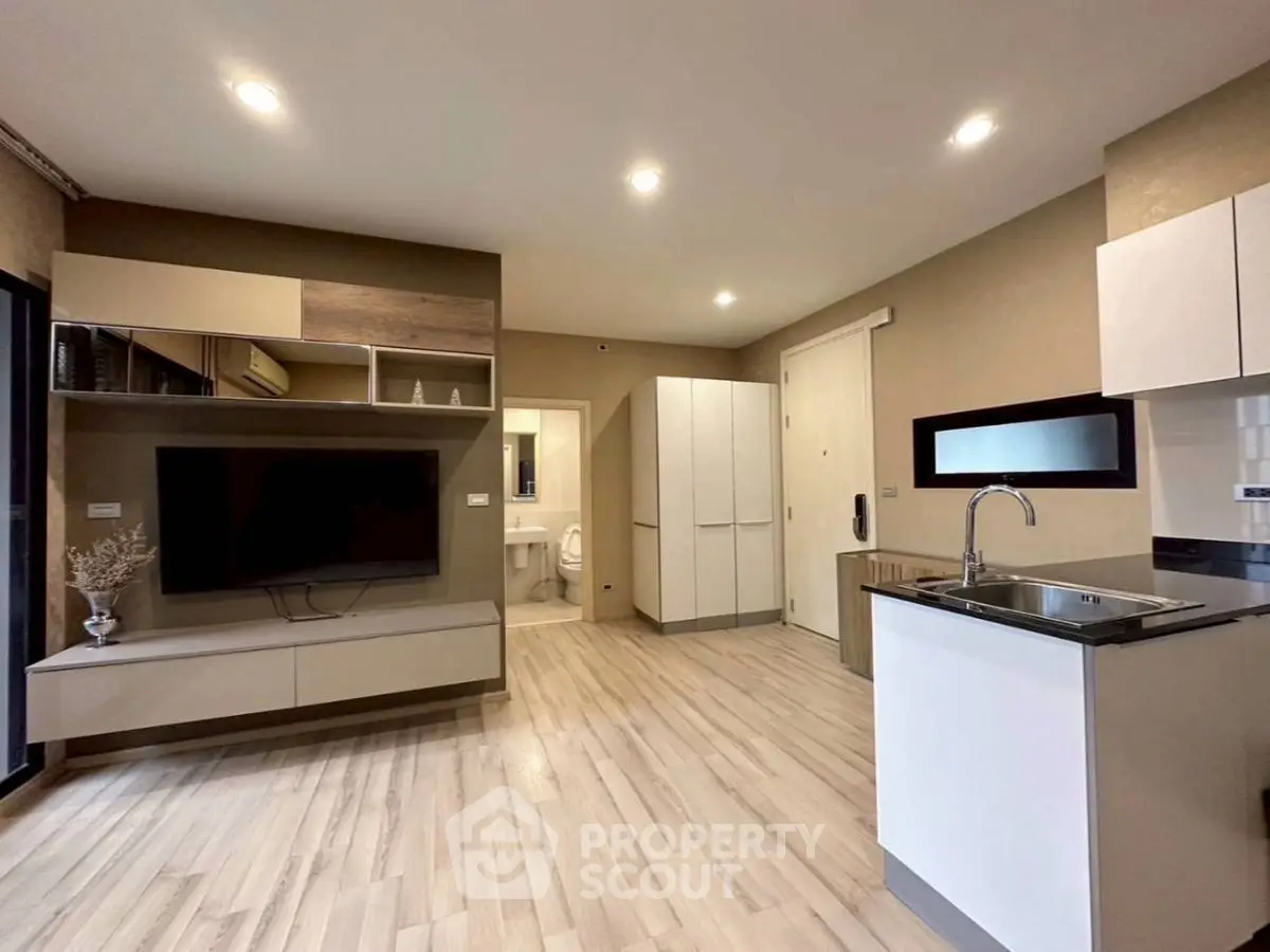 Modern open-plan living room with sleek kitchen and stylish decor