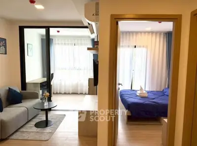 Modern apartment interior with cozy living room and stylish bedroom, featuring elegant decor and natural light.