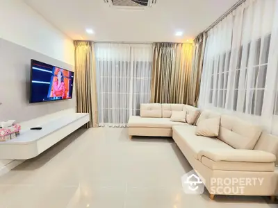 Spacious modern living room with elegant beige sofas and wall-mounted TV