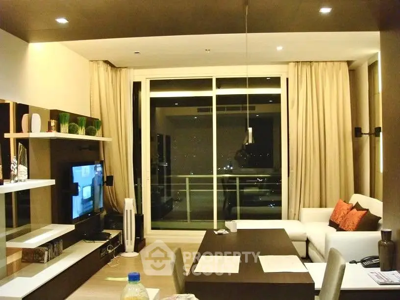 Modern living room with large windows and stylish decor in a high-rise apartment.