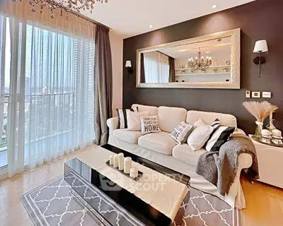 Elegant living room with chic decor and large window offering city views