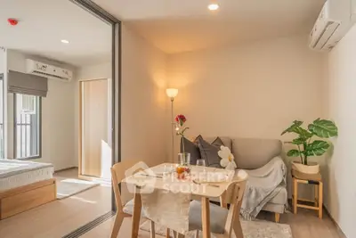 Cozy modern living room with dining area and bedroom view