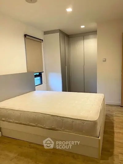 Modern bedroom with sleek wardrobe and comfortable mattress, perfect for restful nights.