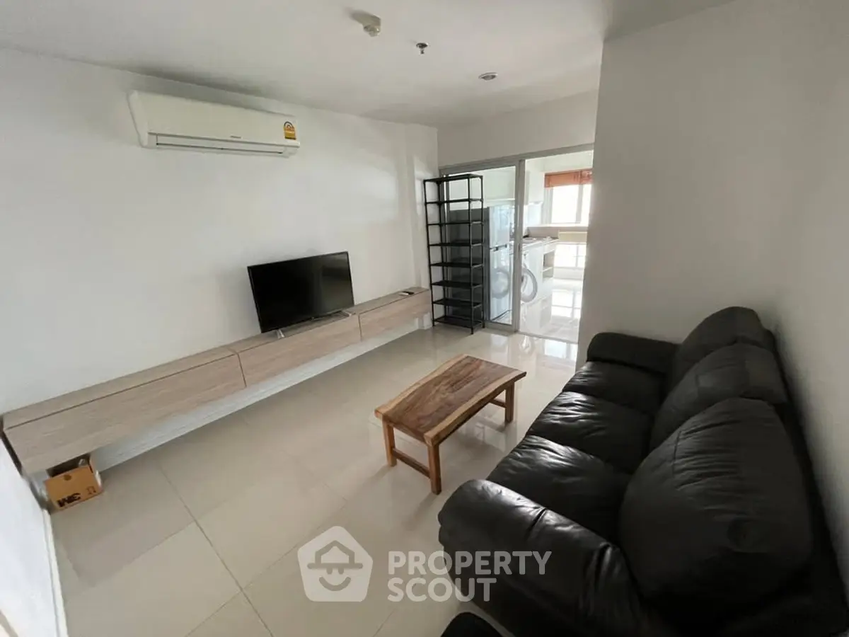 Modern living room with sleek furniture and wall-mounted TV