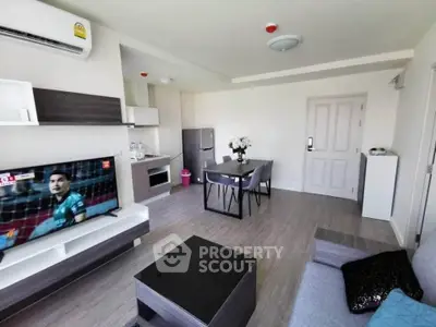 Modern living room with sleek furniture and open kitchen layout in a stylish apartment.