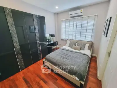 Modern bedroom with sleek wardrobe and cozy bed in stylish apartment