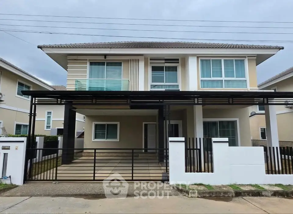 Modern two-story house with sleek design and spacious driveway in a suburban neighborhood.