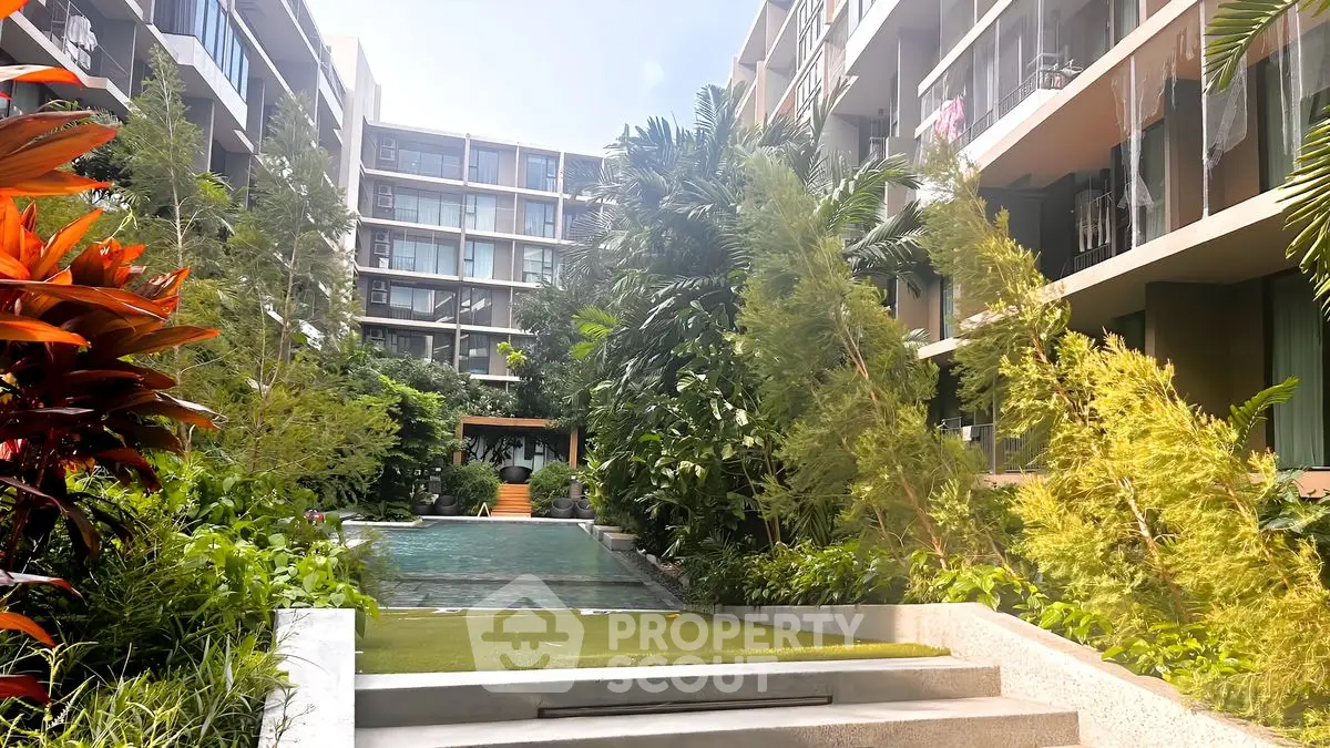 Luxurious apartment complex with lush garden and inviting pool area
