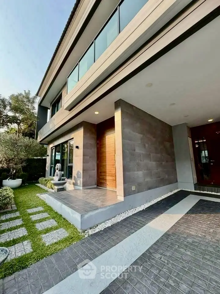 Modern luxury home exterior with stylish entrance and landscaped garden