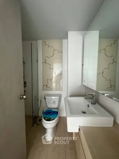 Modern bathroom with sleek fixtures and stylish tile design, perfect for contemporary living.