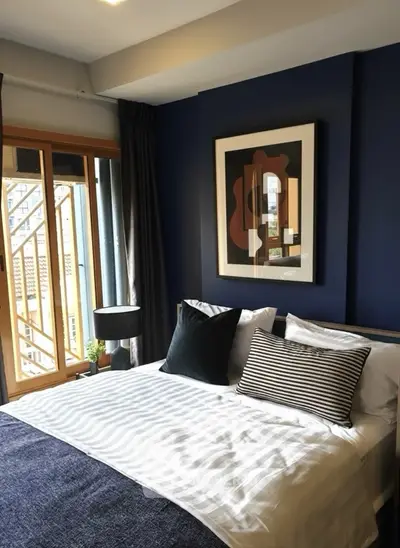 Modern bedroom with stylish decor and large window for natural light