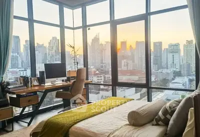Stunning corner bedroom with panoramic city views and modern workspace.