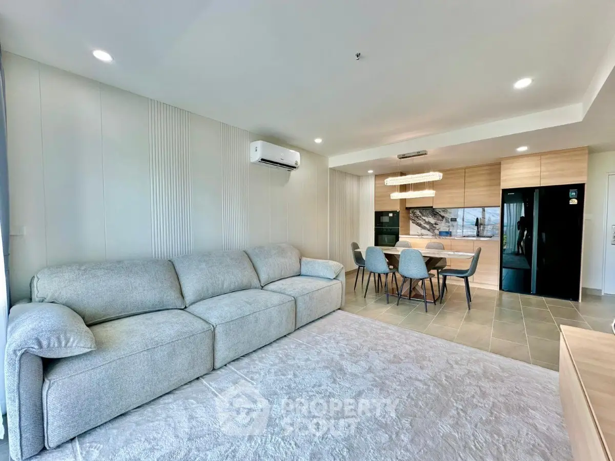 Spacious modern living room with open kitchen and stylish furniture