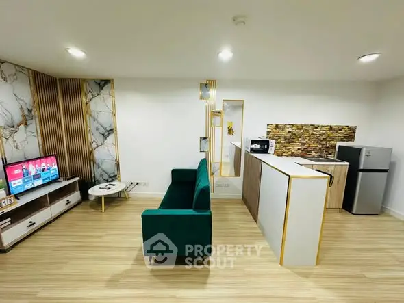 Modern open-layout living room with stylish decor and compact kitchen area.