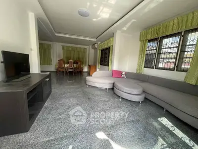 Spacious living room with modern furniture and large windows for natural light.