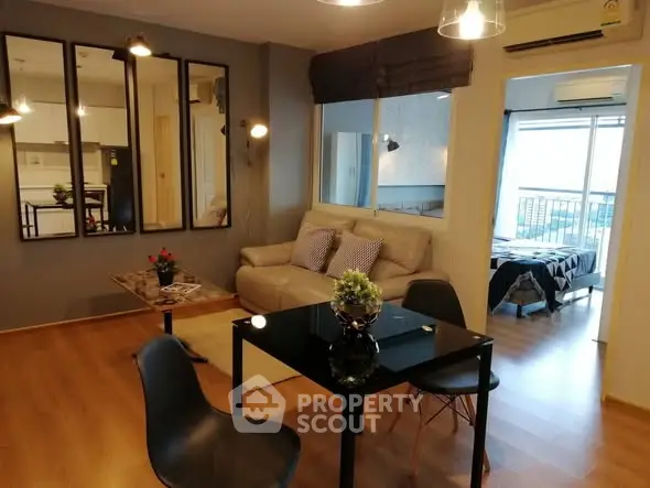 Modern living room with stylish decor and open view to bedroom