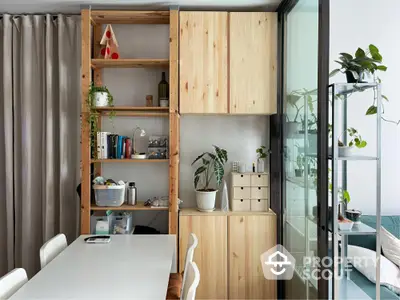 Modern dining area with wooden shelving and indoor plants