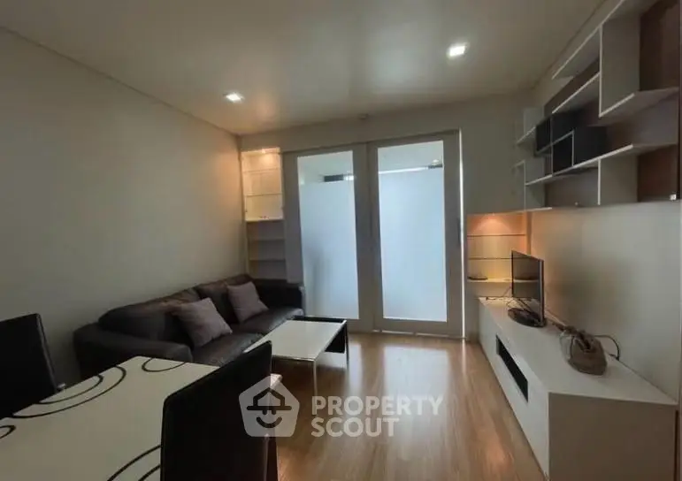 Modern living room with sleek furniture and built-in shelving, perfect for urban living.