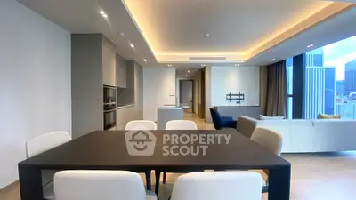 Luxurious open-plan living and dining area with modern furnishings and city view.