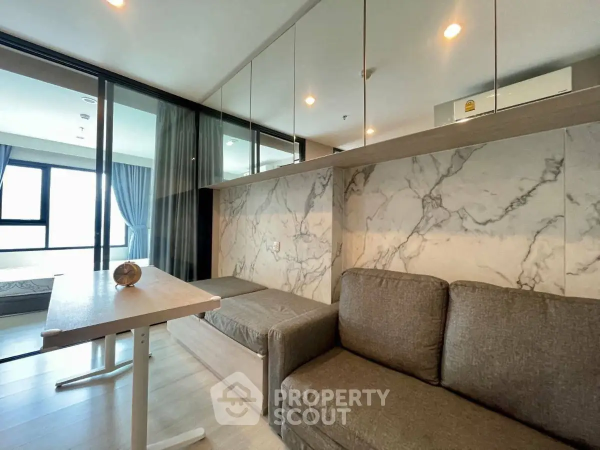 Modern living room with marble accent wall and cozy seating area
