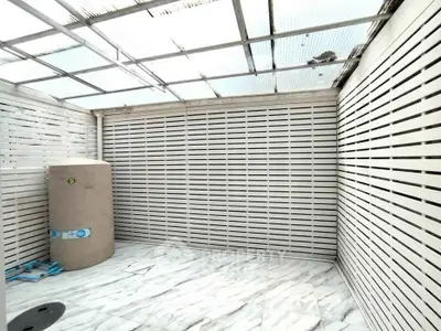 Spacious enclosed balcony with modern design and marble flooring