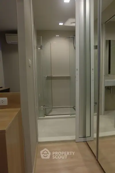 Modern bathroom with glass shower and mirrored closet doors