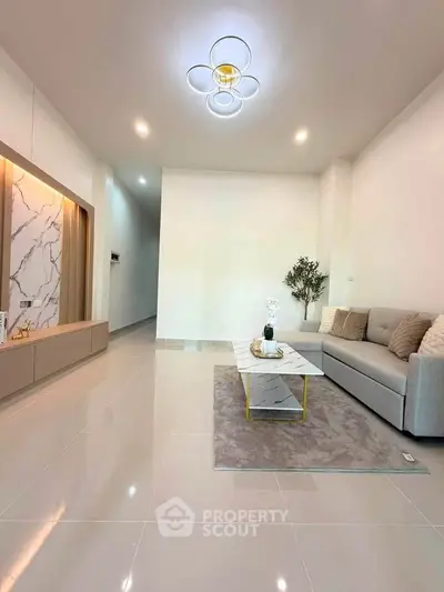 Modern living room with elegant decor and stylish lighting, featuring a cozy sofa and chic coffee table.