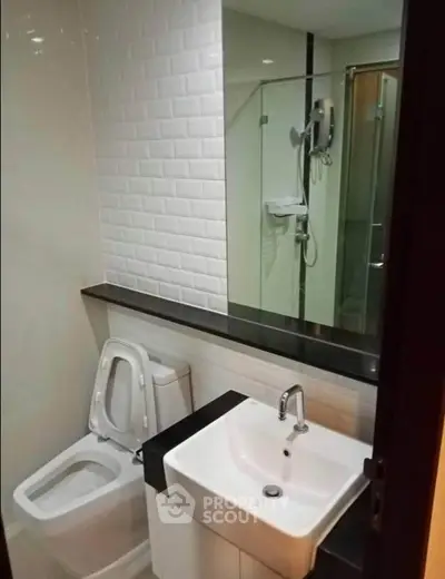 Modern bathroom with sleek fixtures and glass shower enclosure