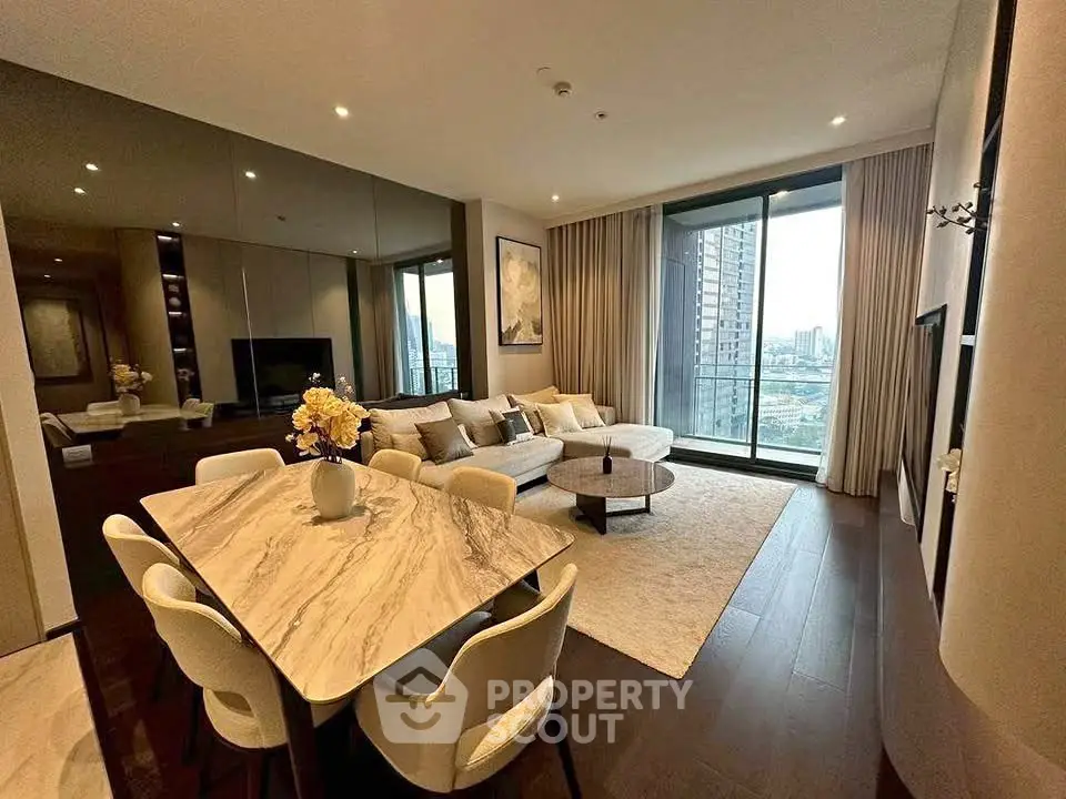 Luxurious modern living room with city view, elegant decor, and spacious layout in high-rise apartment.