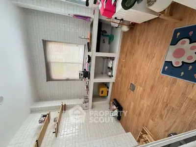 Charming kitchen with white brick walls and wooden flooring, featuring open shelving and ample natural light.
