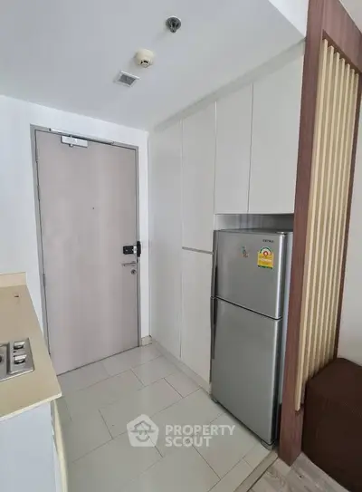 Modern kitchen with sleek fridge and minimalist cabinetry