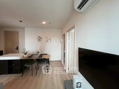 Modern living room with dining area and air conditioning in stylish apartment.