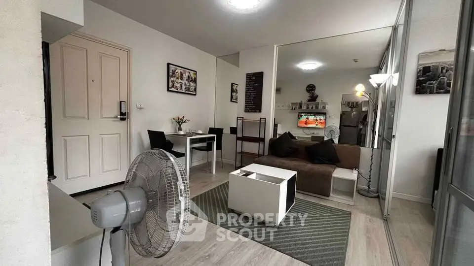 Modern living room with stylish decor and open layout, featuring cozy seating and dining area.