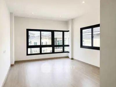 Spacious corner unit with large windows and natural light in modern apartment.