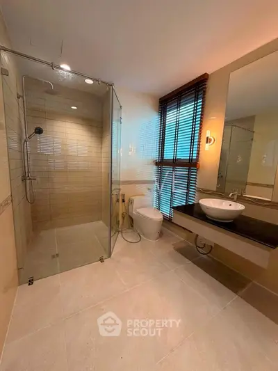Luxurious modern bathroom with glass shower and elegant fixtures