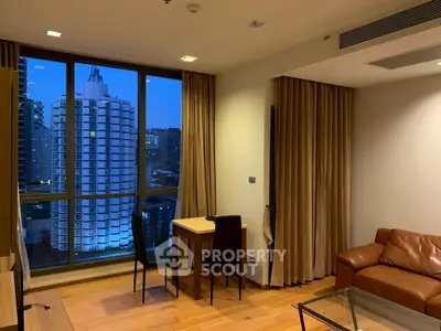 Modern living room with city view, featuring leather sofa and dining area.
